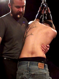 Sir has the boy right where he wants him, arms chained to the ceiling and awaiting punishment.