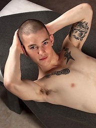 Tattooed twink Mick Gibson shows his fat cock