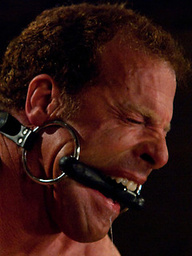 Three doms use and abuse Derek Pain during a live shoot.
